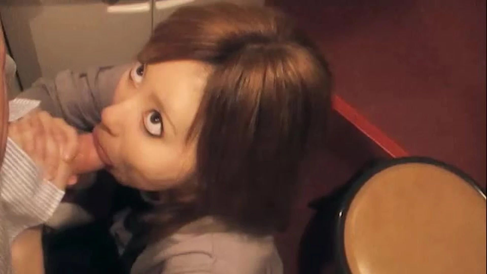 Mona on her knees sucking a cock in the bathroom